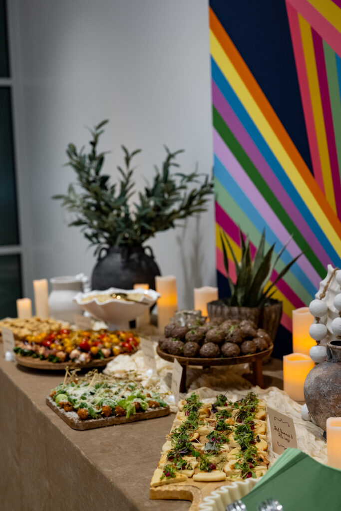 Mediterranean catering display by Sirocco with plated appetizers and candles at the Modern Luxury Nashville one-year anniversary event at Carlock Motors.
