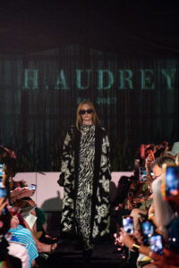 Model walking the runway during the H. Audrey fashion show at the Modern Luxury Nashville one-year anniversary event inside Carlock Motors.