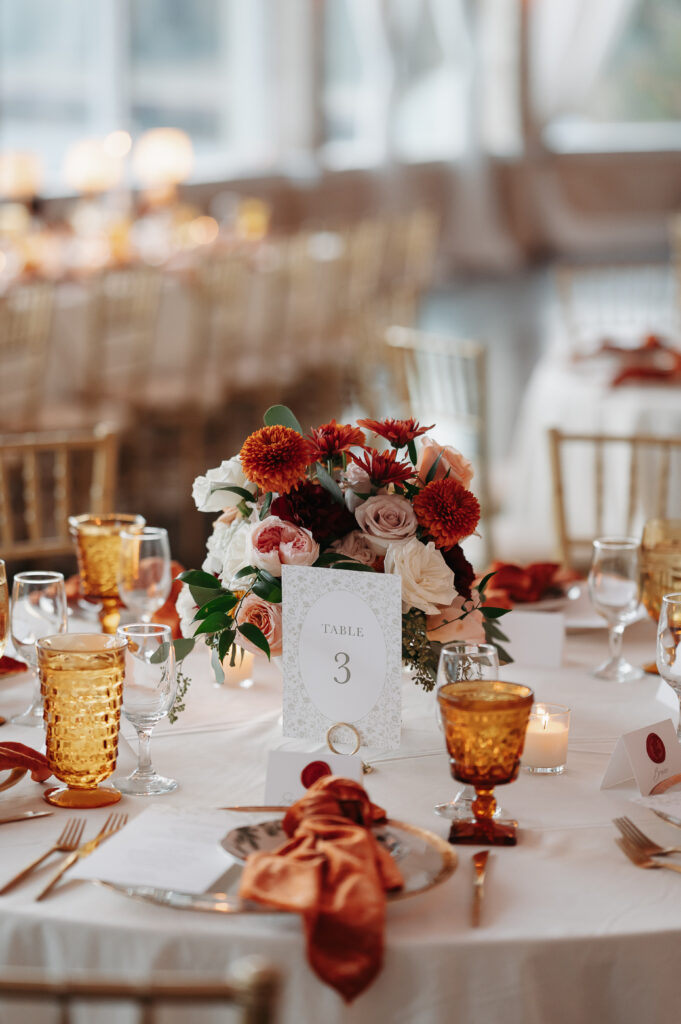 a Fall wedding tablescape with hints of reds and oranges.