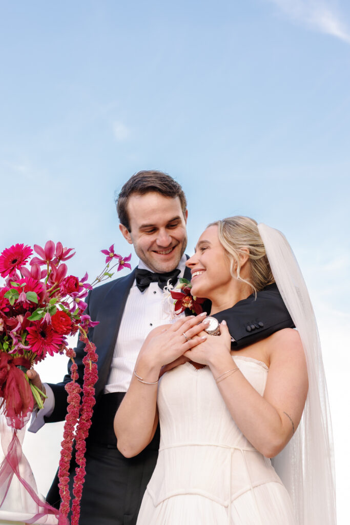 Bride and groom smiling together with fuchsia wedding bouquet in Nashville wedding portrait