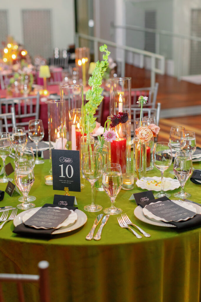 Chartreuse wedding table with candles, floral arrangements, and place settings at Nashville Symphony reception