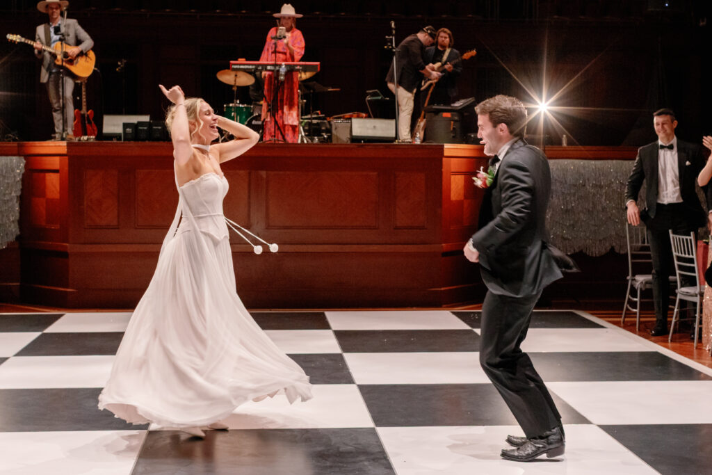 Bride and groom dancing on checkered dance floor during wedding reception at Nashville Symphony