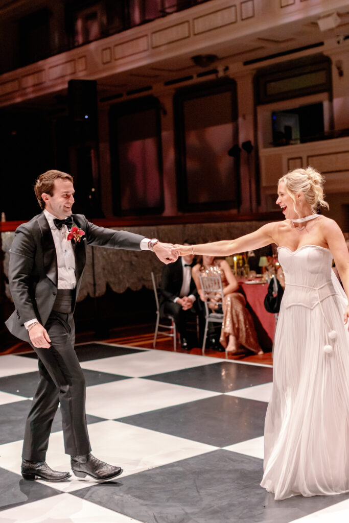 Bride and groom dancing on checkered dance floor during wedding reception at Nashville Symphony